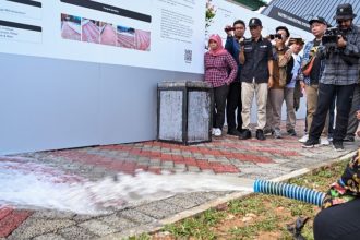 Simulasi penggelontoran air pada solusi beton paving block berpori di area hunian tapak ramah lingkungan SIG di IKN, untuk melihat performa serapan air yang mampu mengurangi limpasan permukaan (surface run-off). (Foto : SIG)